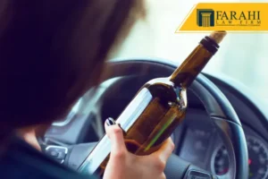 Woman holding bottle while driving
