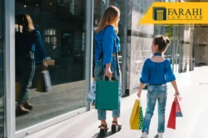 A woman and a girl holding multiple shopping bags outside a shop